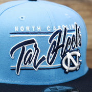 The Tar Heels Wordmark on the North Carolina Tar Heels Team Script Gray Bottom 9Fifty Snapback | Light Blue And Navy Blue Snap Cap