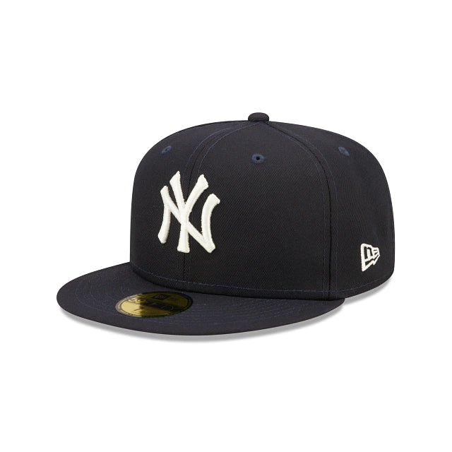The wearer's left on the New York Yankees Pop Sweat Pastel World Series Side Patch Fitted Cap With Pink Undervisor | Navy Blue 59Fifty Cap