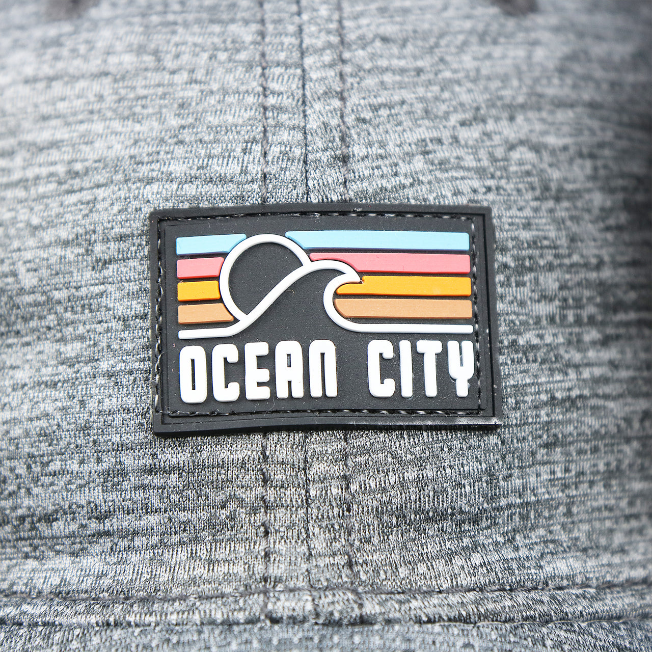 The Ocean City Sunset Rubber Patch on the New Jersey High Point PVC Ocean City Rubber Patch Cool Fit Adjustable Dad Hat | Performance Gray Dad Hat