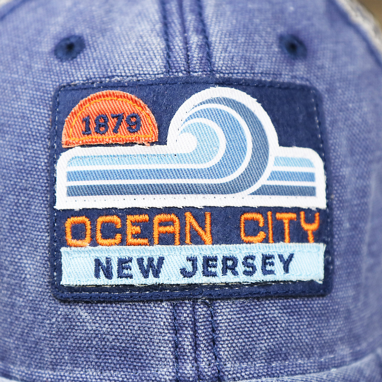The Ocean City Patch on the OCNJ 1879 Ocean City New Jersey Wave Denim Inspired Trucker Hat | Navy And Khaki Mesh Trucker Hat
