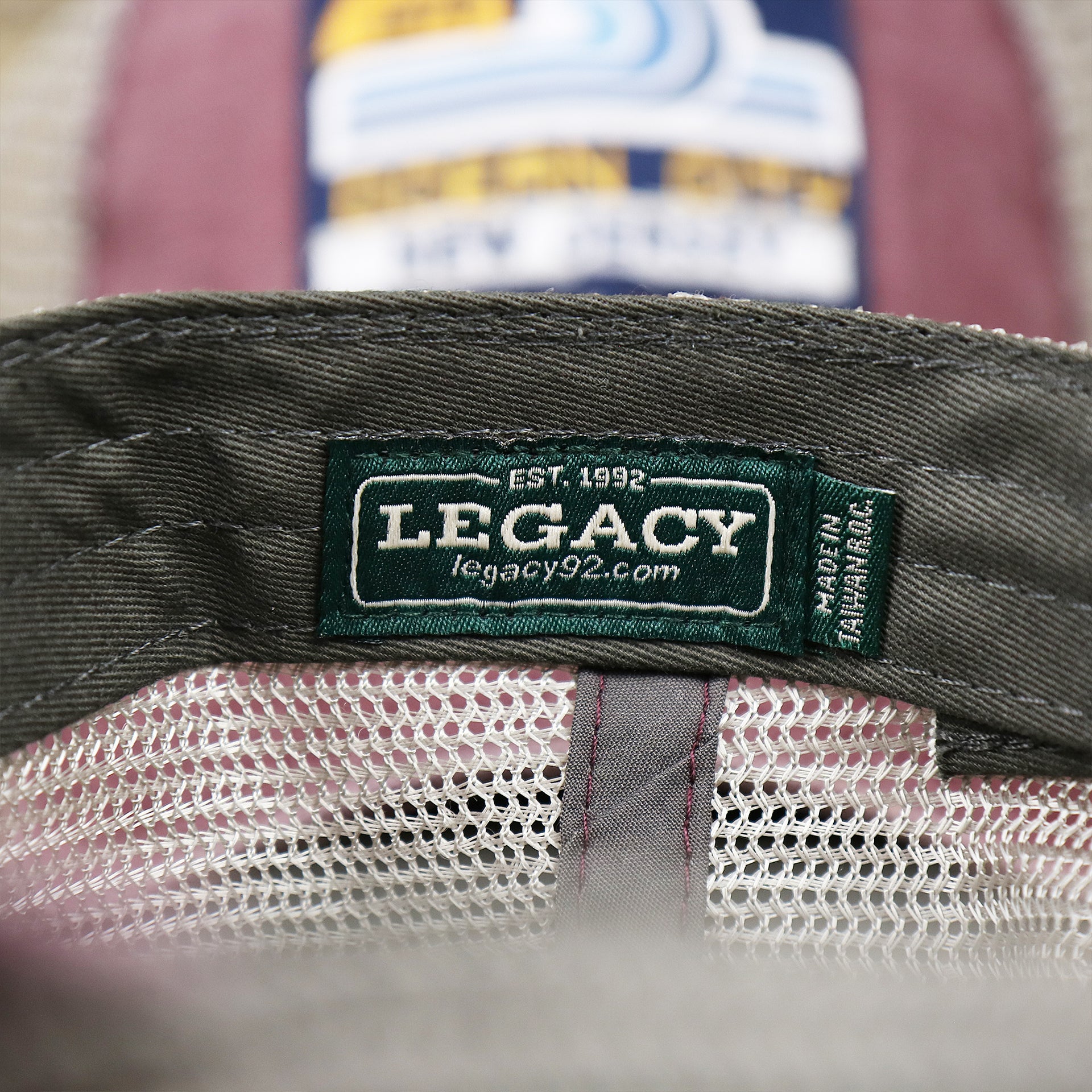 The Legacy Tag on the OCNJ 1879 Ocean City New Jersey Wave Trucker Hat | Burgundy And Khaki Mesh Trucker Hat