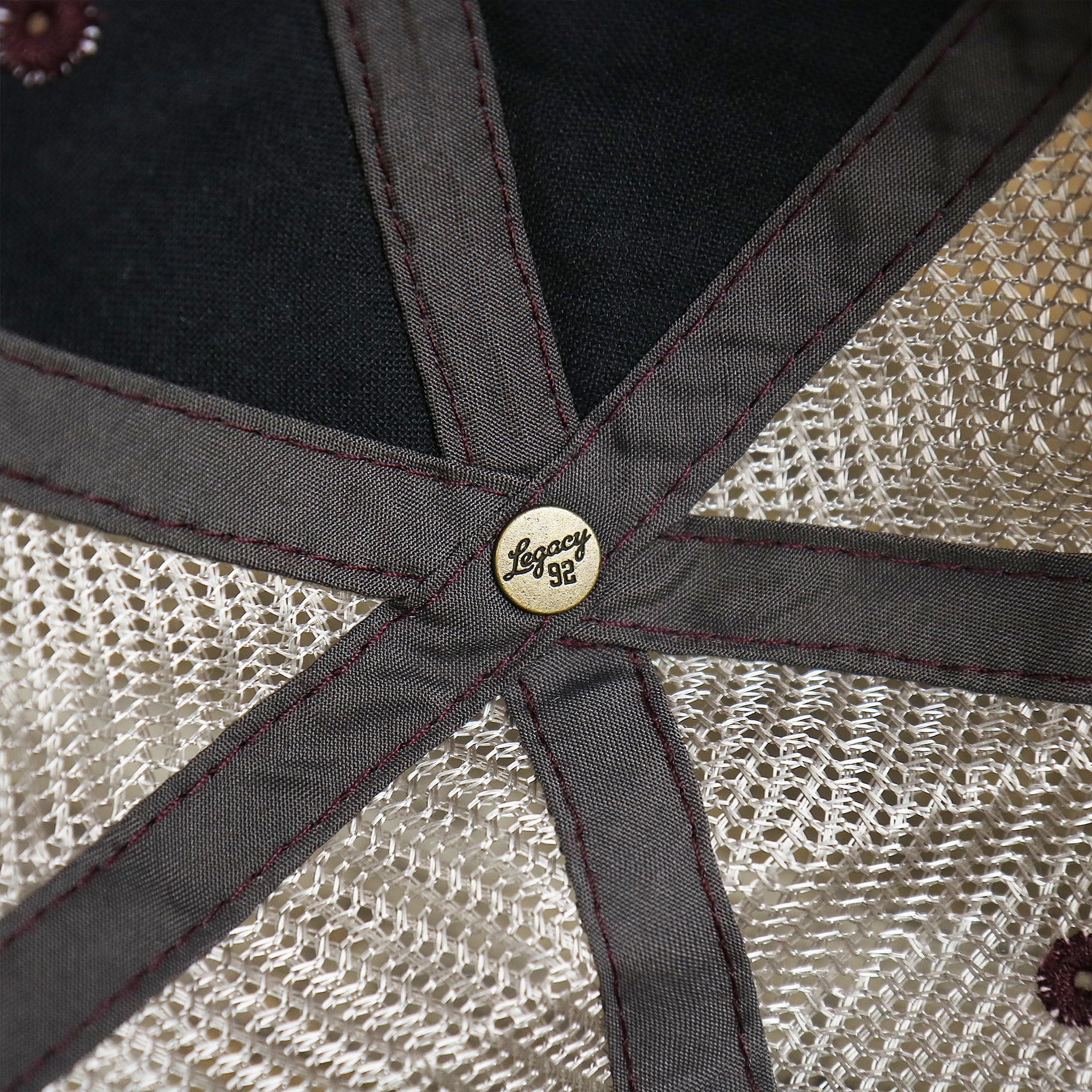 The Legacy Engraved Button on the OCNJ 1879 Ocean City New Jersey Wave Trucker Hat | Burgundy And Khaki Mesh Trucker Hat