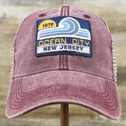 The front of the OCNJ 1879 Ocean City New Jersey Wave Trucker Hat | Burgundy And Khaki Mesh Trucker Hat