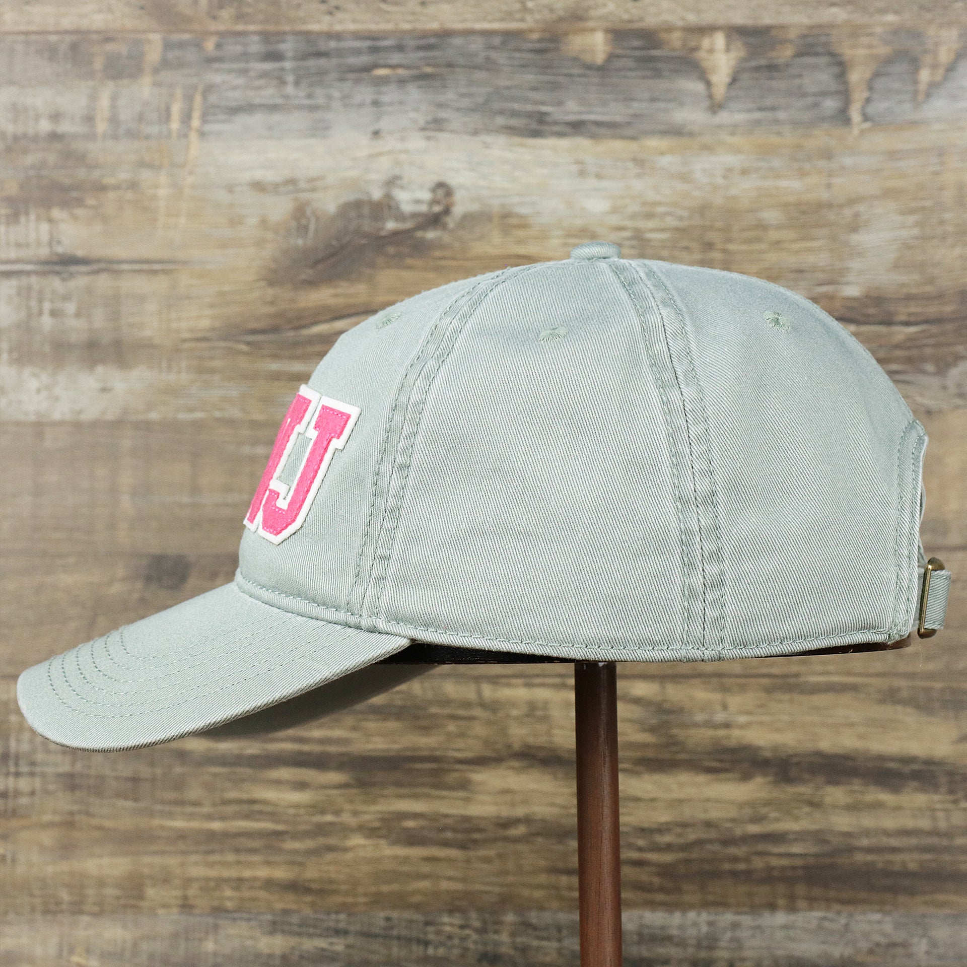 The wearer's left on the Pink OCNJ Wordmark White Outline Dad Hat | Sawgrass Dad Hat