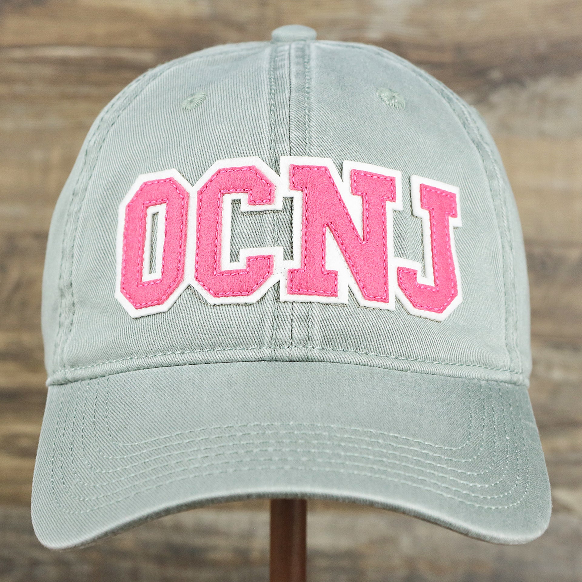 The front of the Pink OCNJ Wordmark White Outline Dad Hat | Sawgrass Dad Hat