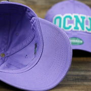 The undervisor on the Teal OCNJ Double Wordmark White Outline Bucket Hat | Lavender Bucket Hat
