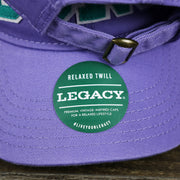 The Legacy Sticker on the Teal OCNJ Double Wordmark White Outline Bucket Hat | Lavender Bucket Hat