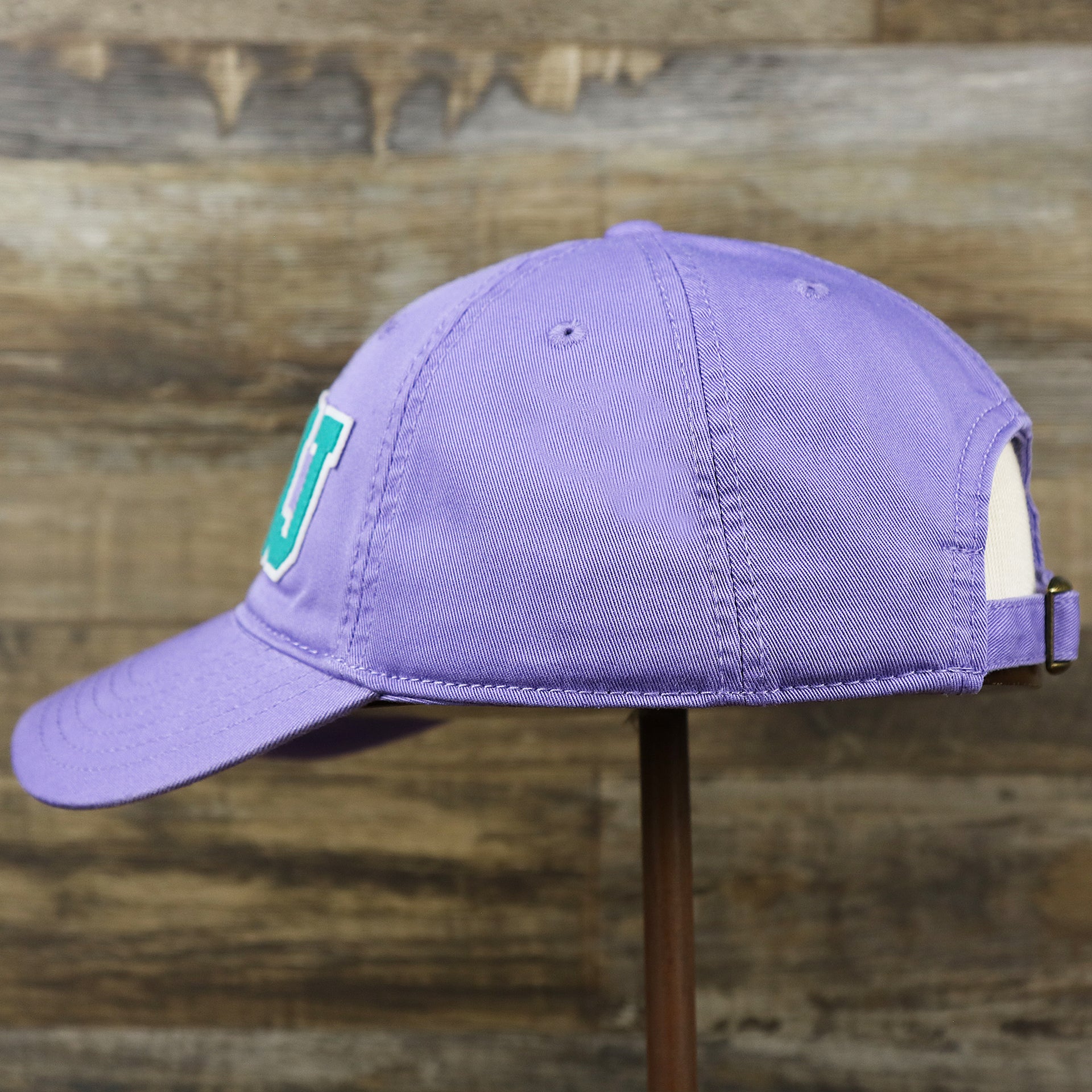 The wearer's left on the Teal OCNJ Double Wordmark White Outline Bucket Hat | Lavender Bucket Hat