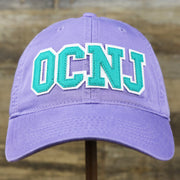 The front of the Teal OCNJ Double Wordmark White Outline Bucket Hat | Lavender Bucket Hat