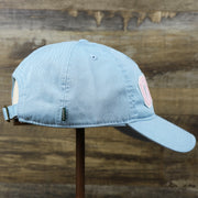 The wearer's right on the Pink OCNJ Wordmark White Outline Dad Hat | Light Blue Dad Hat
