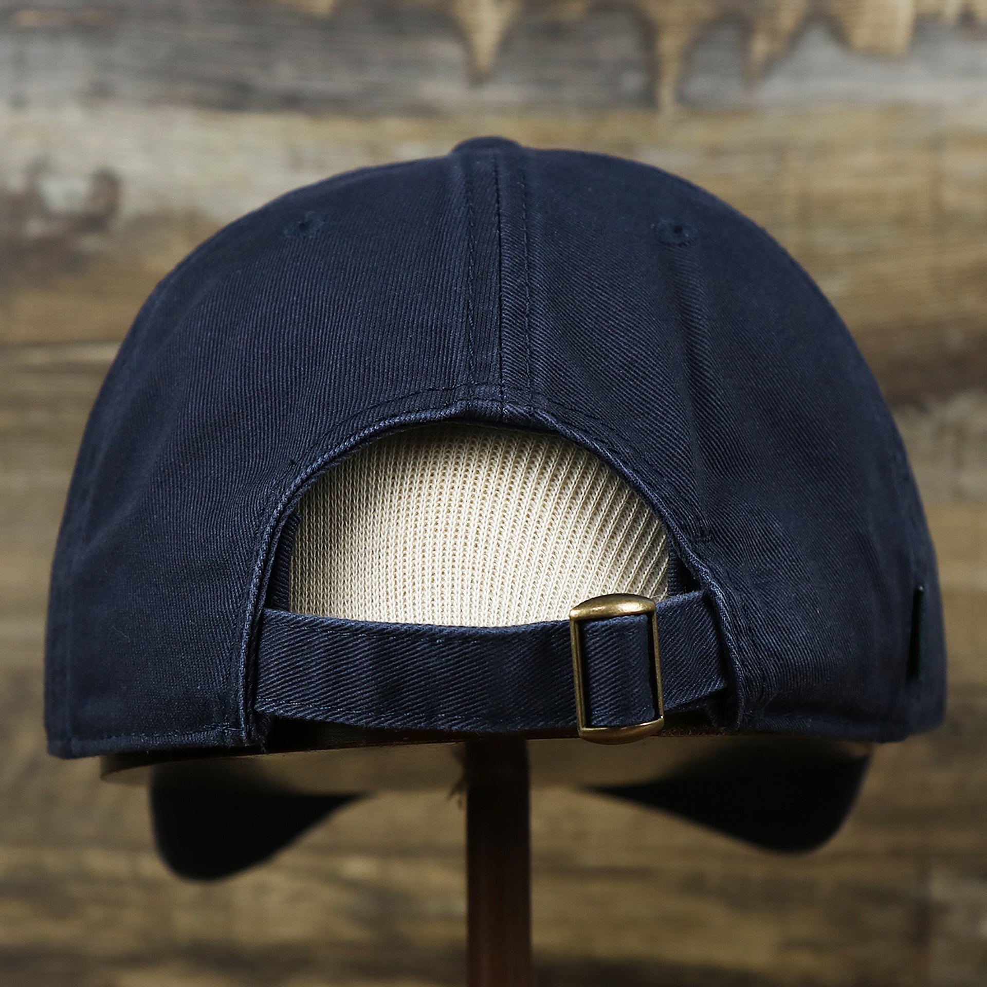 The backside of the Light Blue OCNJ Wordmark White Outline Dad Hat | Navy Blue Dad Hat