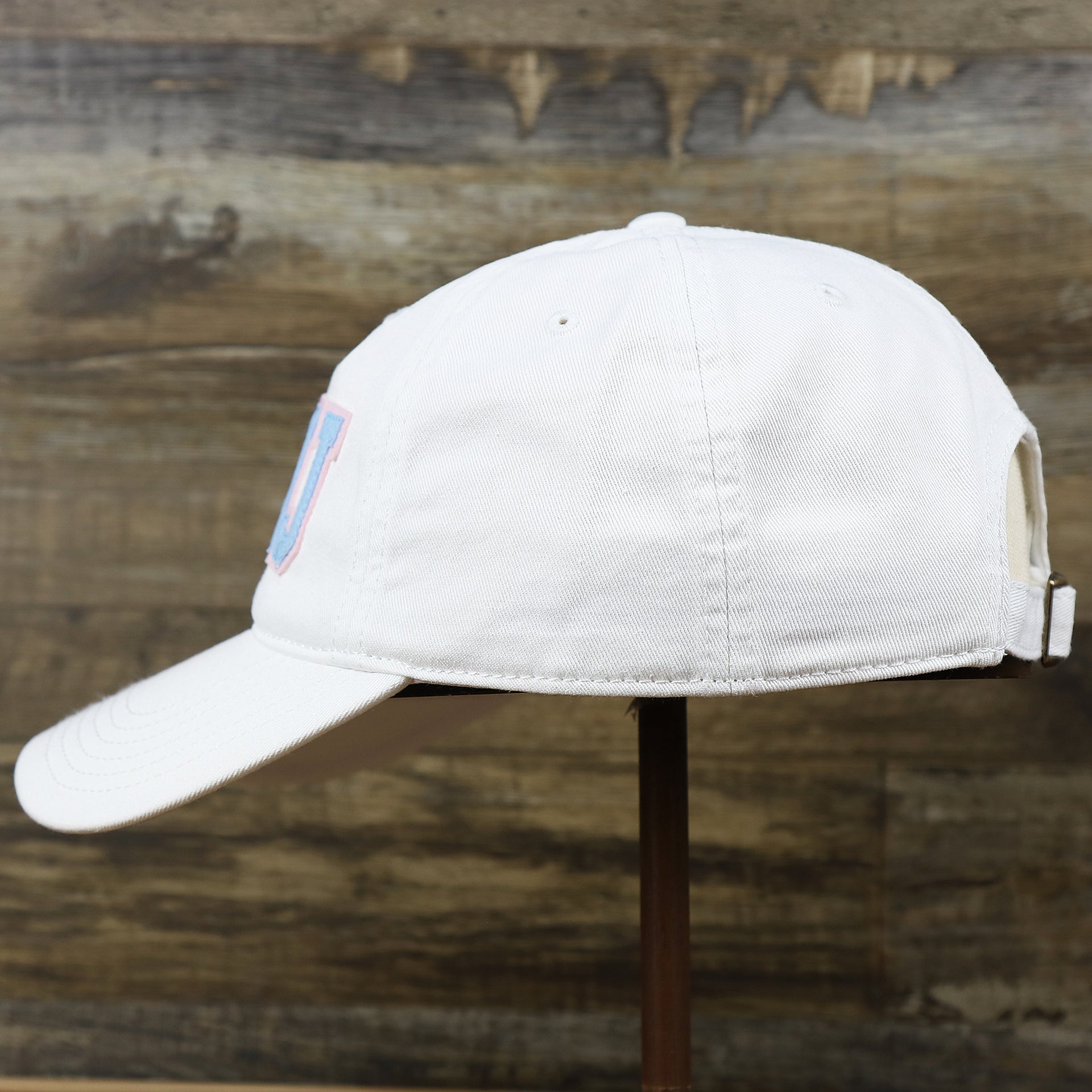 The wearer's left on the Light Blue OCNJ Wordmark Pink Outline Dad Hat | White Dad Hat