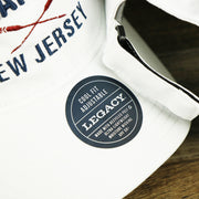 The Legacy Sticker on the Ocean City New Jersey Wordmark Crossed Oars Logo Dad Hat | White Dad Hat