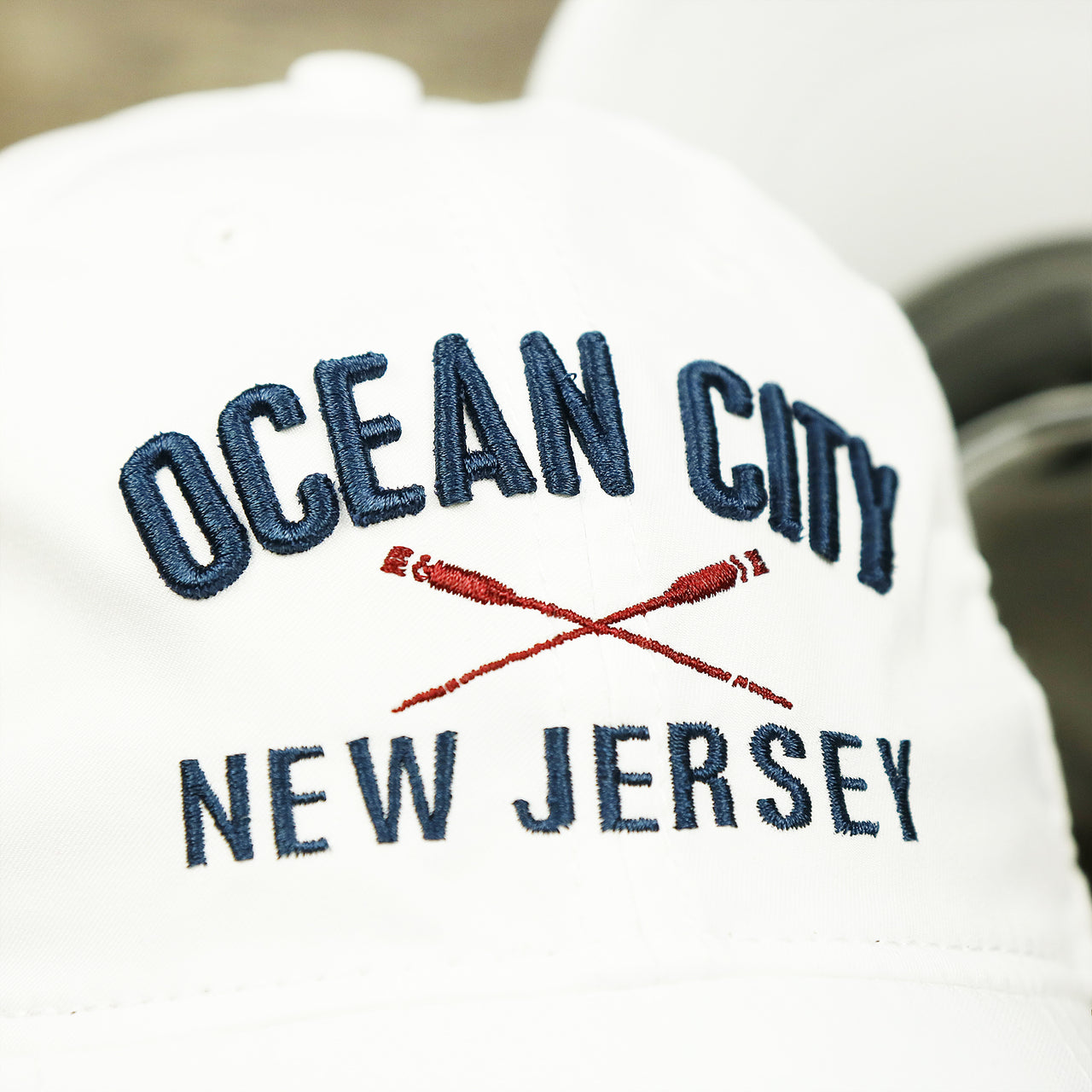 The Ocean City Oars Logo on the Ocean City New Jersey Wordmark Crossed Oars Logo Dad Hat | White Dad Hat