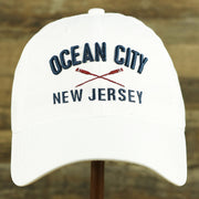The front of the Ocean City New Jersey Wordmark Crossed Oars Logo Dad Hat | White Dad Hat