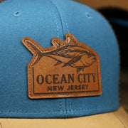 The Tune Leather Patch on the Ocean City Leather Tuna Patch New Jersey Mesh Back Trucker Hat | Marine Blue Mesh Trucker Hat