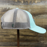 The wearer's right on the New Jersey Ocean City Sunset Mesh Back Trucker Hat | Tahiti Blue And Grey Mesh Trucker Hat