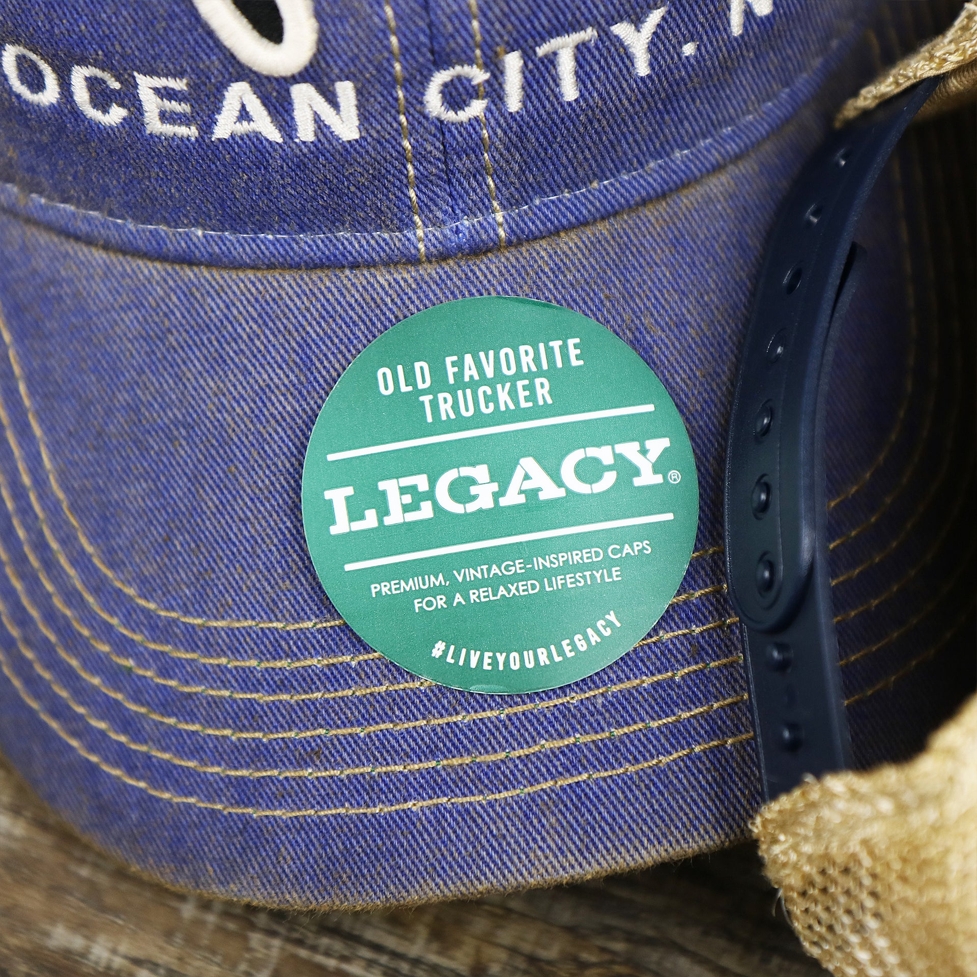 The Legacy Sticker on the Ocean City Horizon Shark Vintage Mesh Back Worn Colorway Trucker Hat | Blue Trucker Hat
