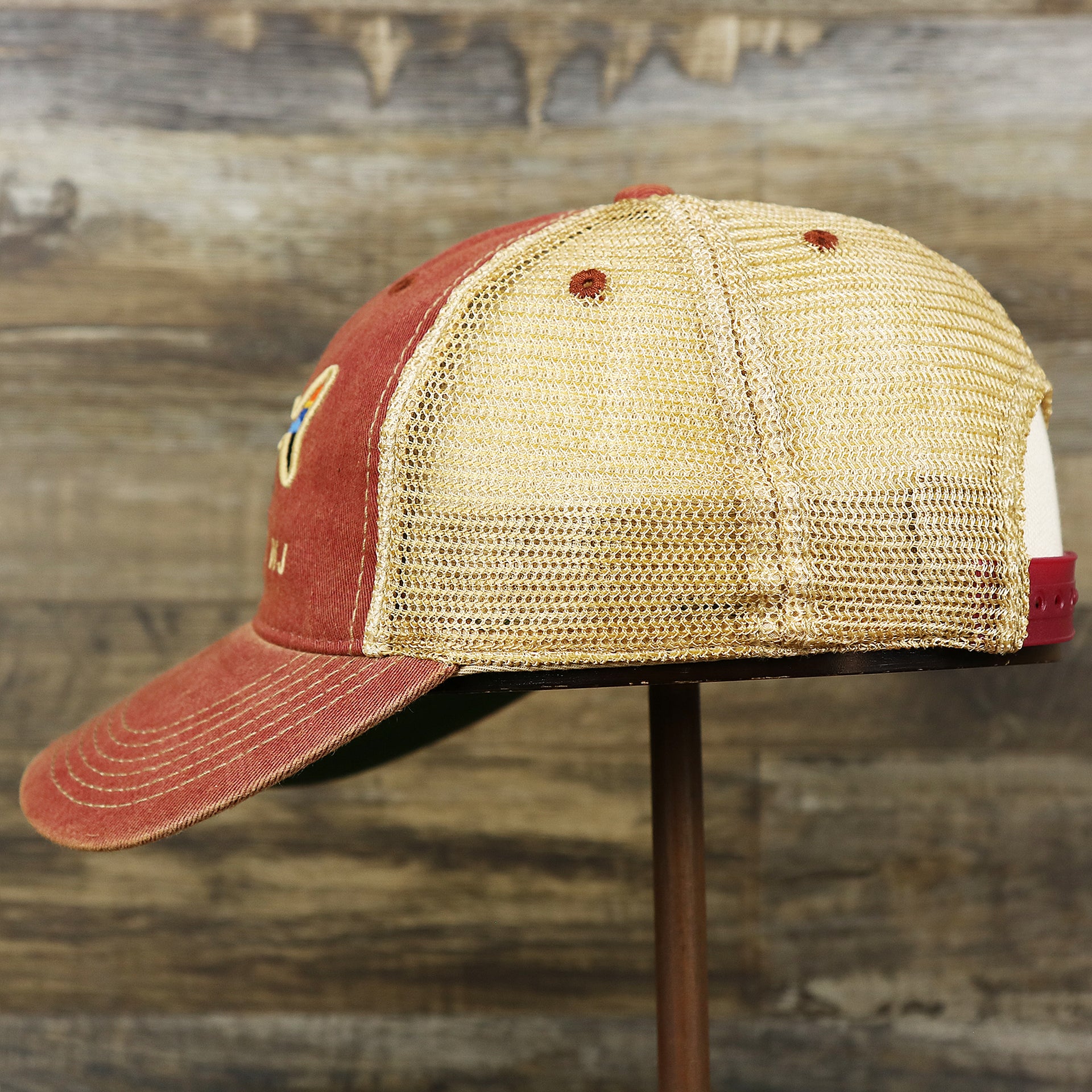The wearer's left on the Youth Ocean City Horizon Shark Vintage Mesh Back Worn Colorway Trucker Hat | Cardinal Trucker Hat