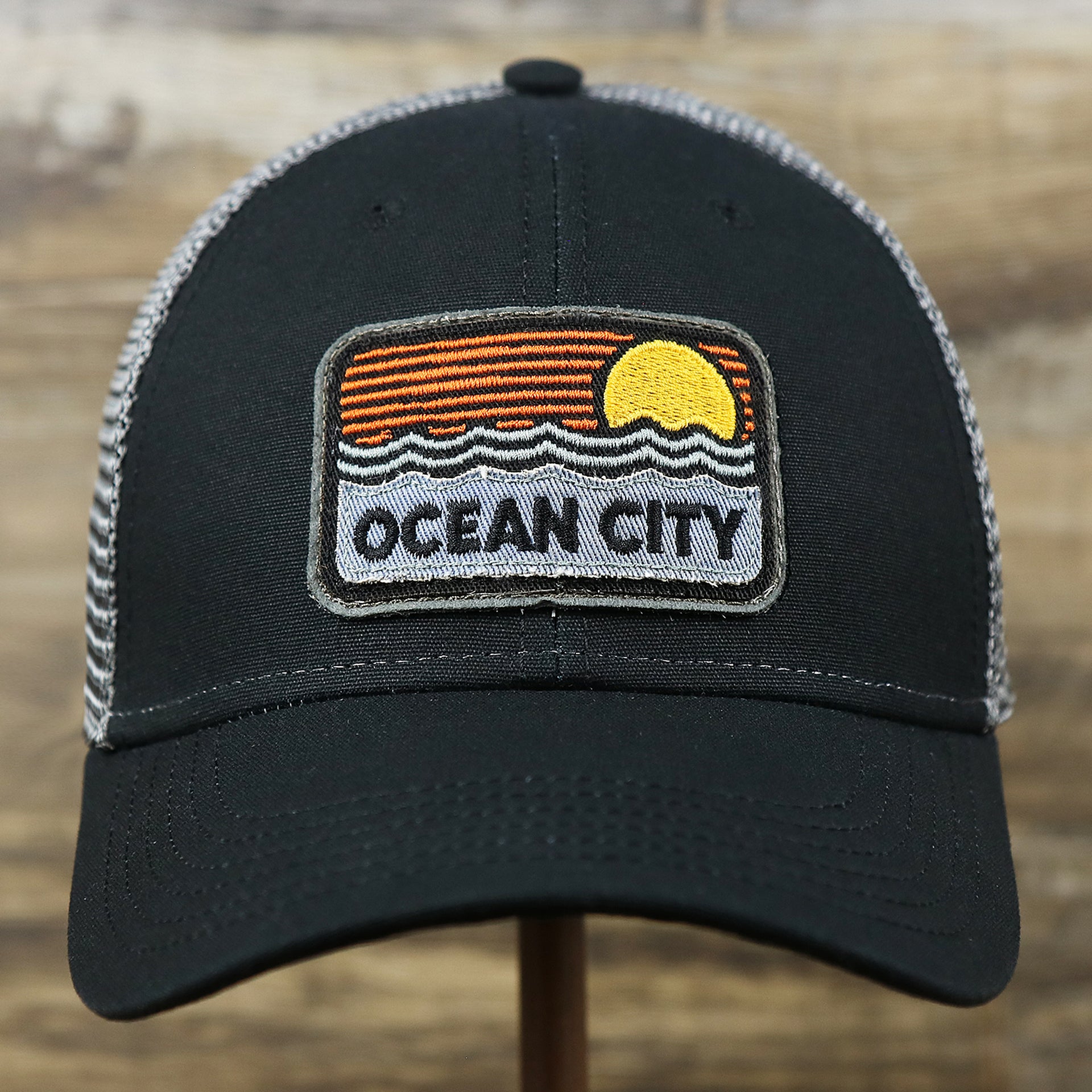 The front of the Youth New Jersey Ocean City Sunset Mesh Back Trucker Hat | Tahiti Blue And Grey Mesh Trucker Hat