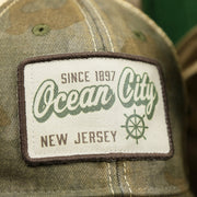 The Ocean City Patch on the Ocean City New Jersey Since 1897 Helm Patch Camo Print Mesh Back Trucker Hat | Camo Green Trucker Hat