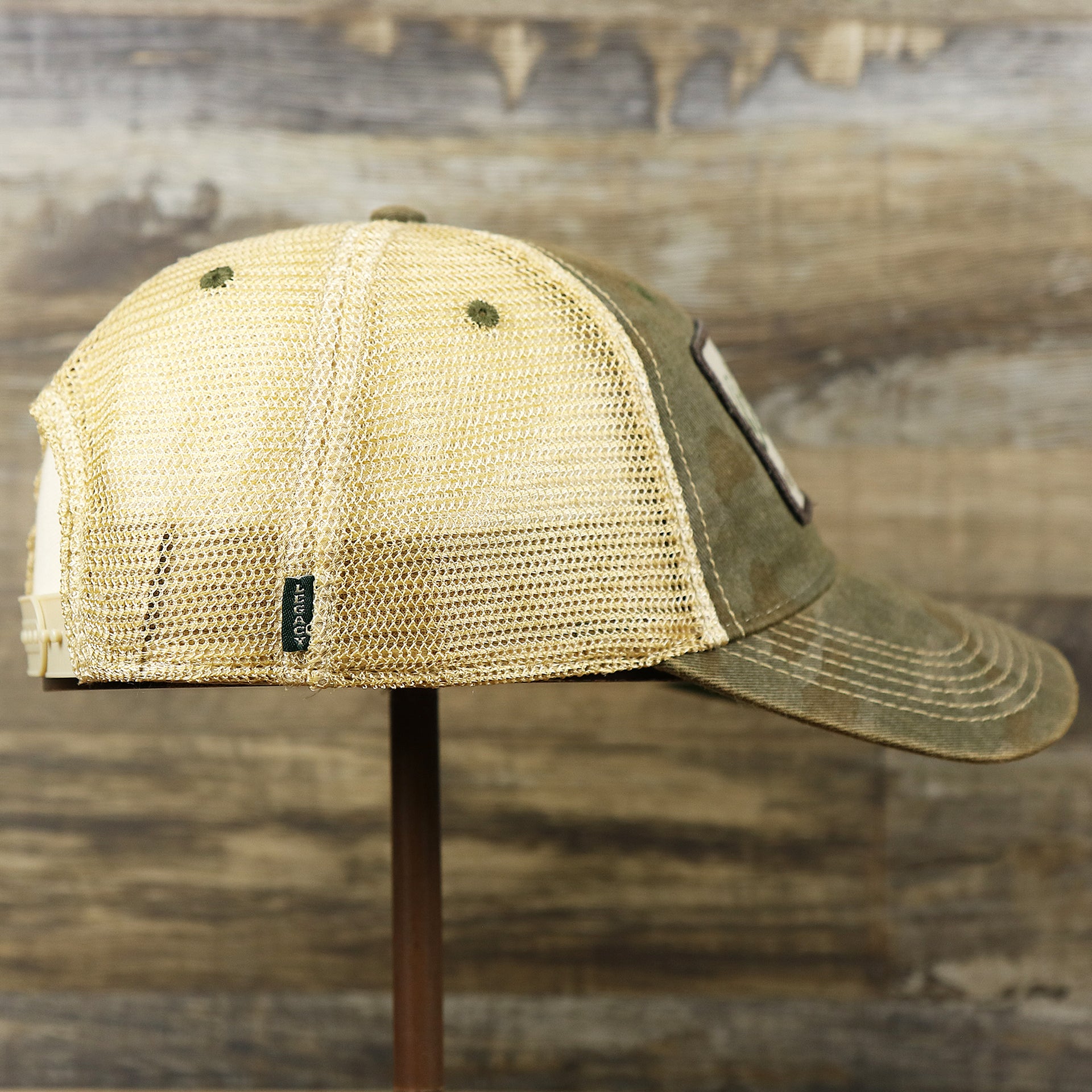 The wearer's right on the Ocean City New Jersey Since 1897 Helm Patch Camo Print Mesh Back Trucker Hat | Camo Green Trucker Hat