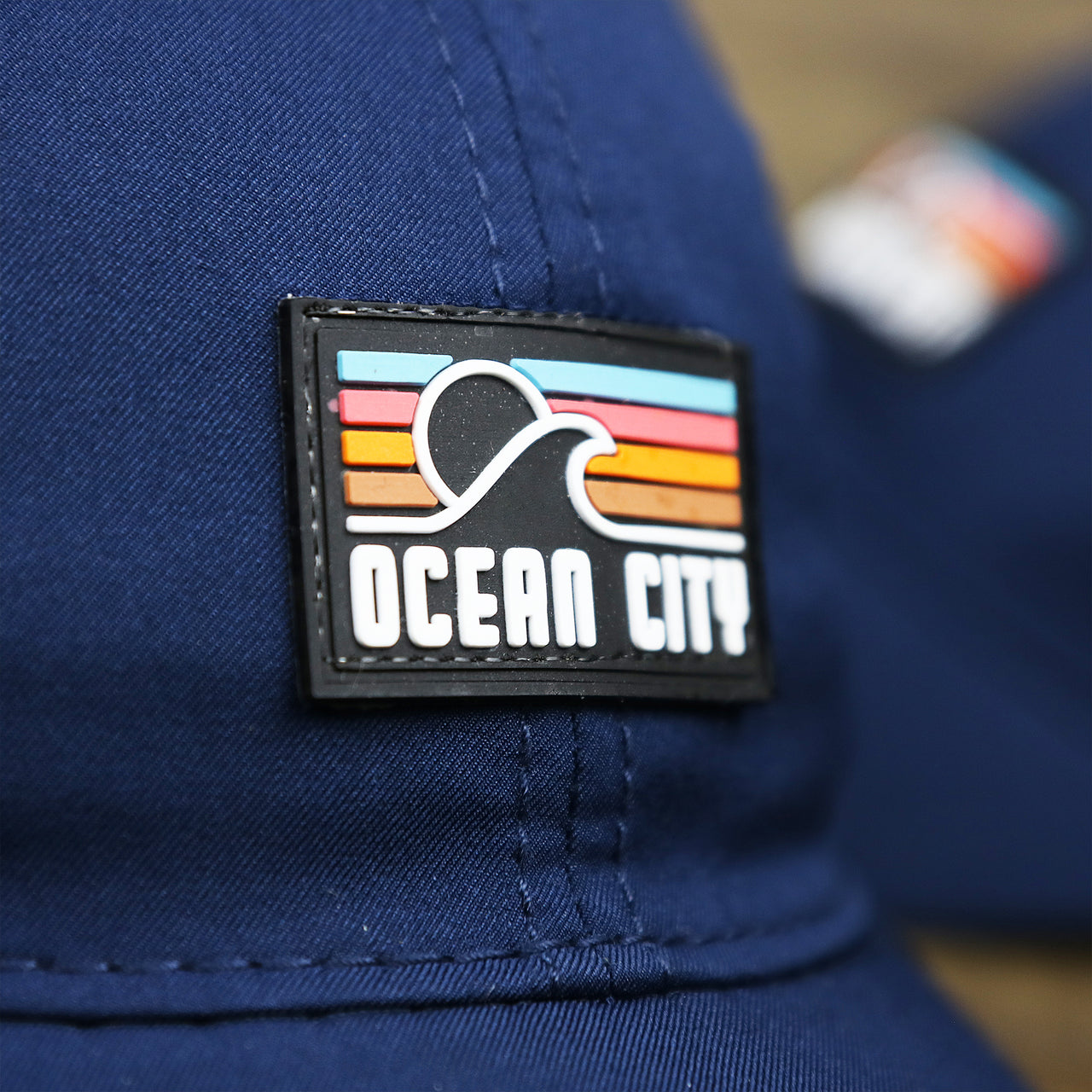 The Ocean City Sunset Rubber Patch on the New Jersey High Point PVC Ocean City Rubber Patch Cool Fit Adjustable Dad Hat | Navy Blue Dad Hat
