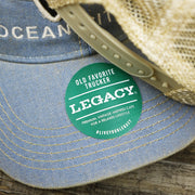 The Legacy Sticker on the Ocean City Horizon Shark Vintage Mesh Back Worn Colorway Trucker Hat | Light Blue Trucker Hat
