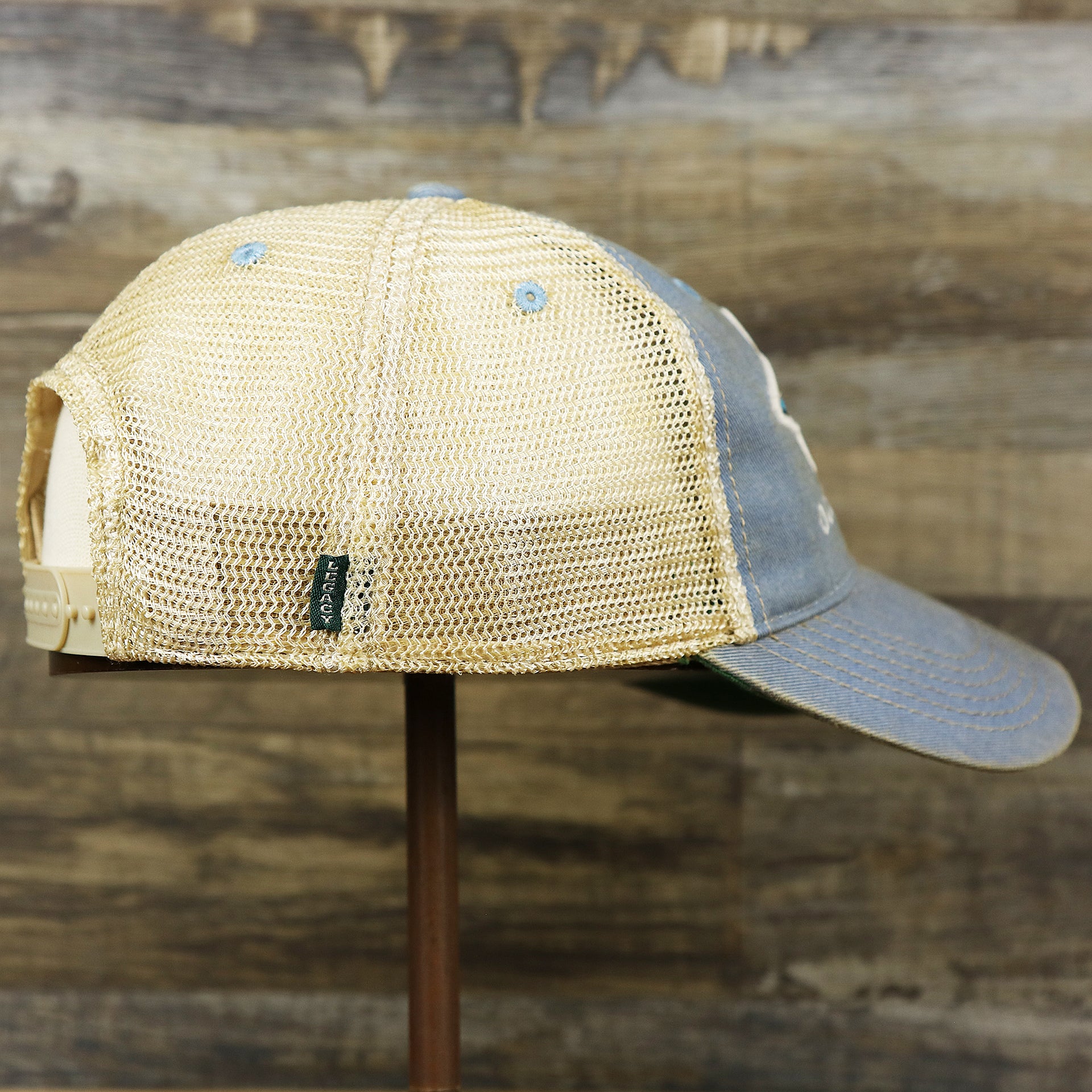 The wearer's right on the Ocean City Horizon Shark Vintage Mesh Back Worn Colorway Trucker Hat | Light Blue Trucker Hat