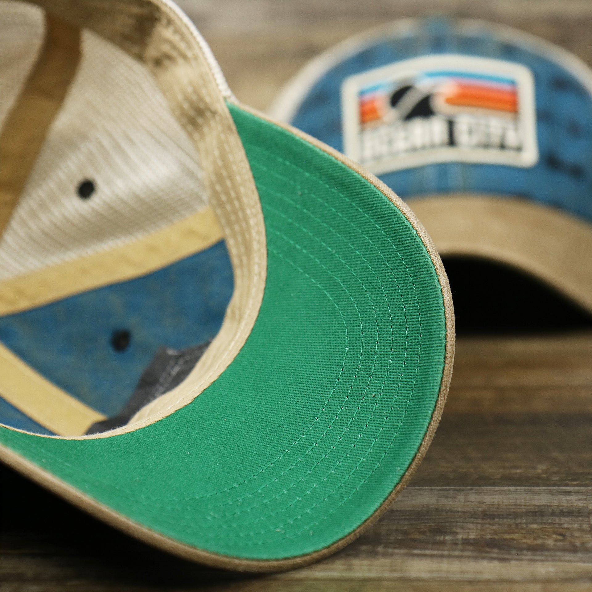 The undervisor on the Ocean City Sunset Patch Fishing Lure Print Mesh Back Trucker Hat | Marine Blue Trucker Hat