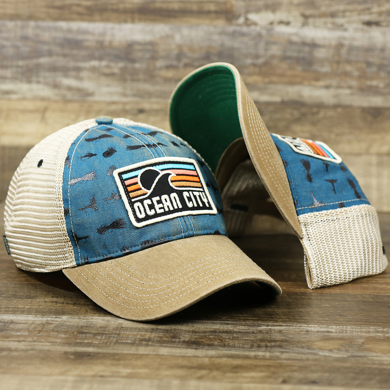 The Ocean City Sunset Patch Fishing Lure Print Mesh Back Trucker Hat | Marine Blue Trucker Hat