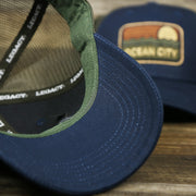 The undervisor on the New Jersey Ocean City Sunset Mesh Back Trucker Hat | Navy Blue And Olive Mesh Trucker Hat