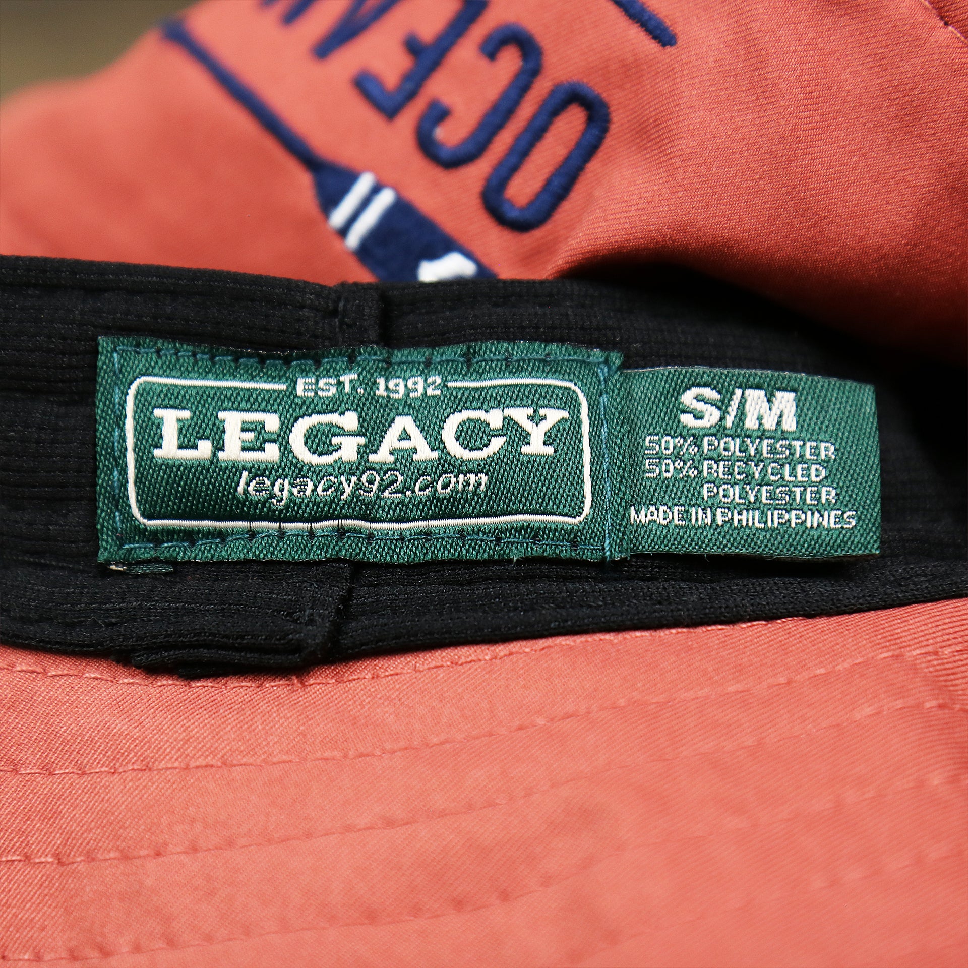 The Legacy Tag on the New Jersey Ocean City Parallel Oars Cool Fit Boonie Hat | Nantucket Red Bucket Hat