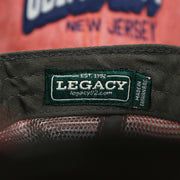 The Legacy Tag on the OCNJ Block Ocean City Wordmark Mesh Trucker Hat | Nantucket Red Trucker Hat