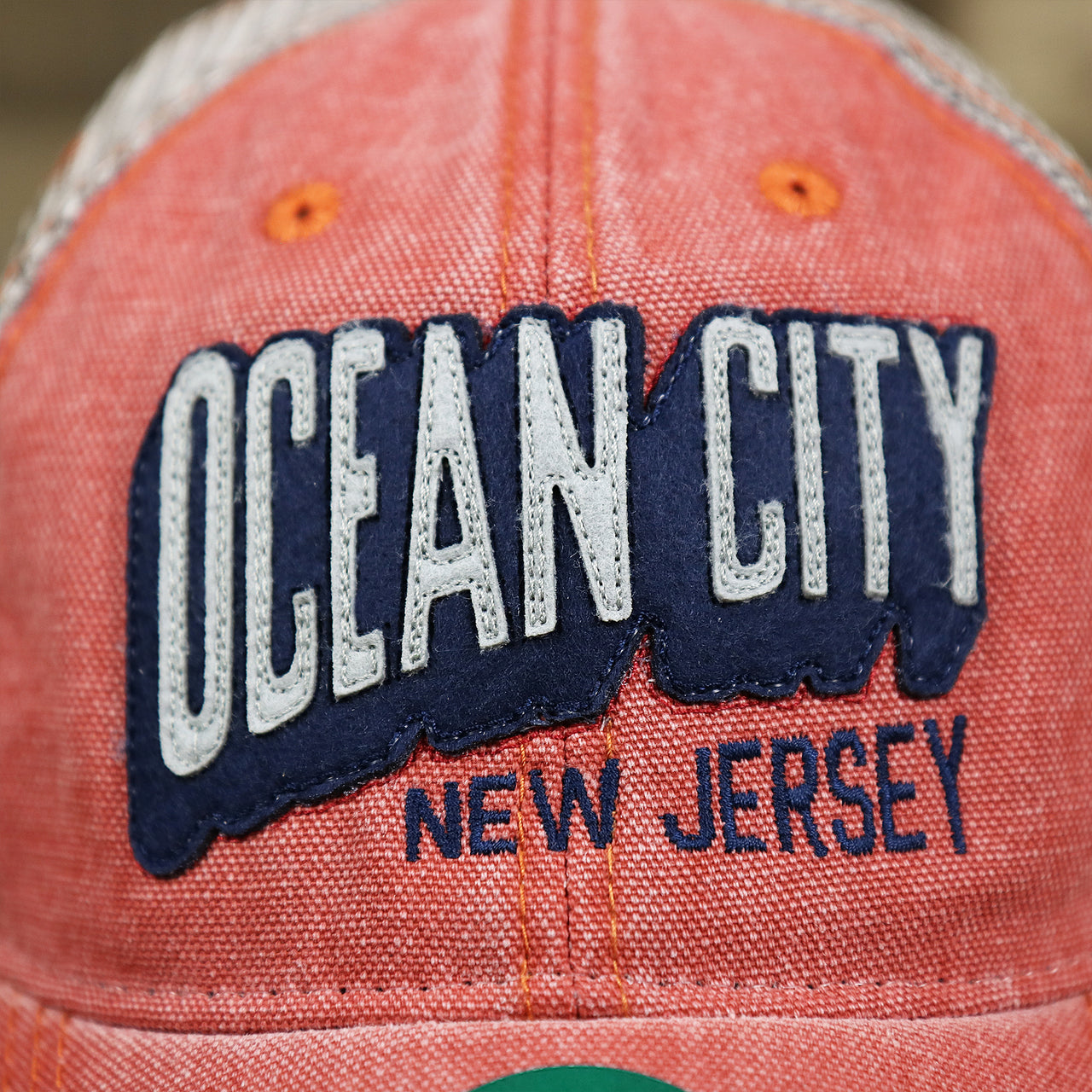 The OCNJ Wordmark on the OCNJ Block Ocean City Wordmark Mesh Trucker Hat | Nantucket Red Trucker Hat