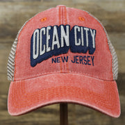 The front of the OCNJ Block Ocean City Wordmark Mesh Trucker Hat | Nantucket Red Trucker Hat
