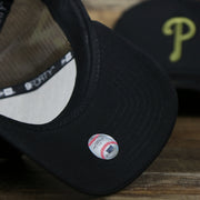 The undervisor on the Philadelphia Phillies Alpha Industries Flying A Mesh Print 9Forty Trucker Hat With Flight Tag | Black Trucker Hat