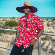 The front of the Philadelphia Phillies Authentic Hawaiian Print Performance Polo Shirt | Red with matching Phillies Straw hat 