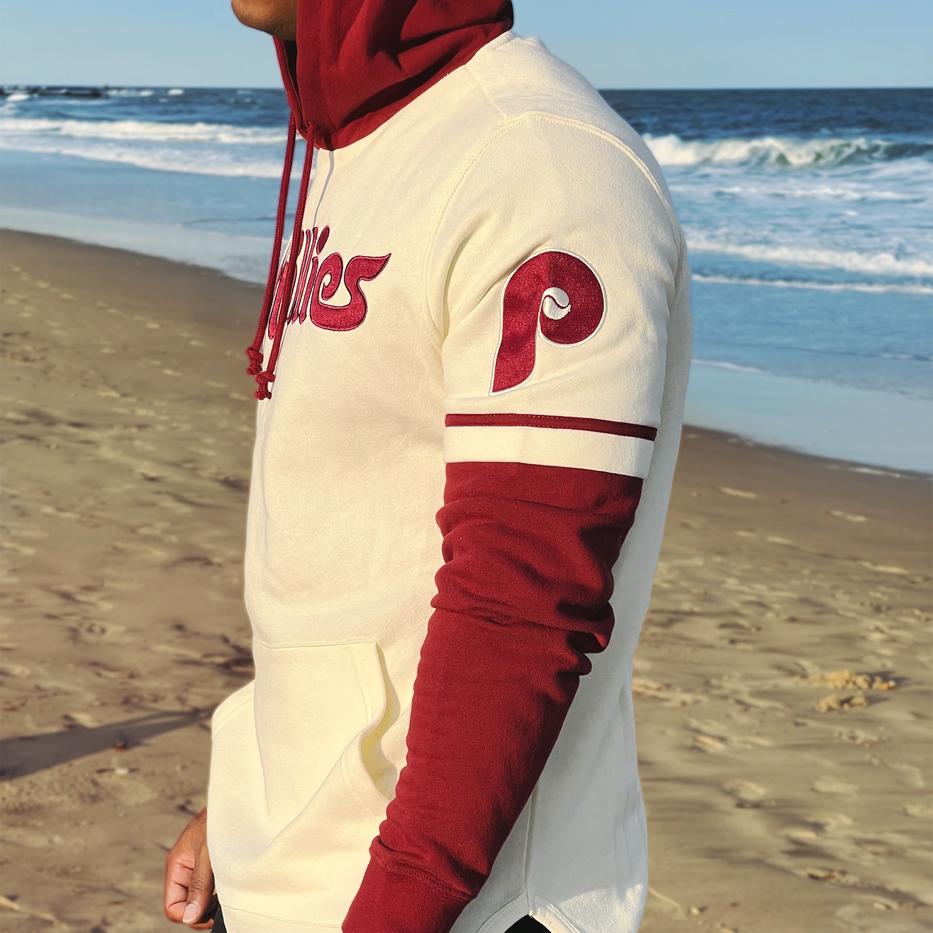 The Phillies Cooperstown Logo on the Cooperstown Philadelphia Phillies Wordmark Retro Phillies Colorway Trifecta Shortstop Layered Hoodie With MLB Side Patch | Cream And Maroon Pullover Hoodie