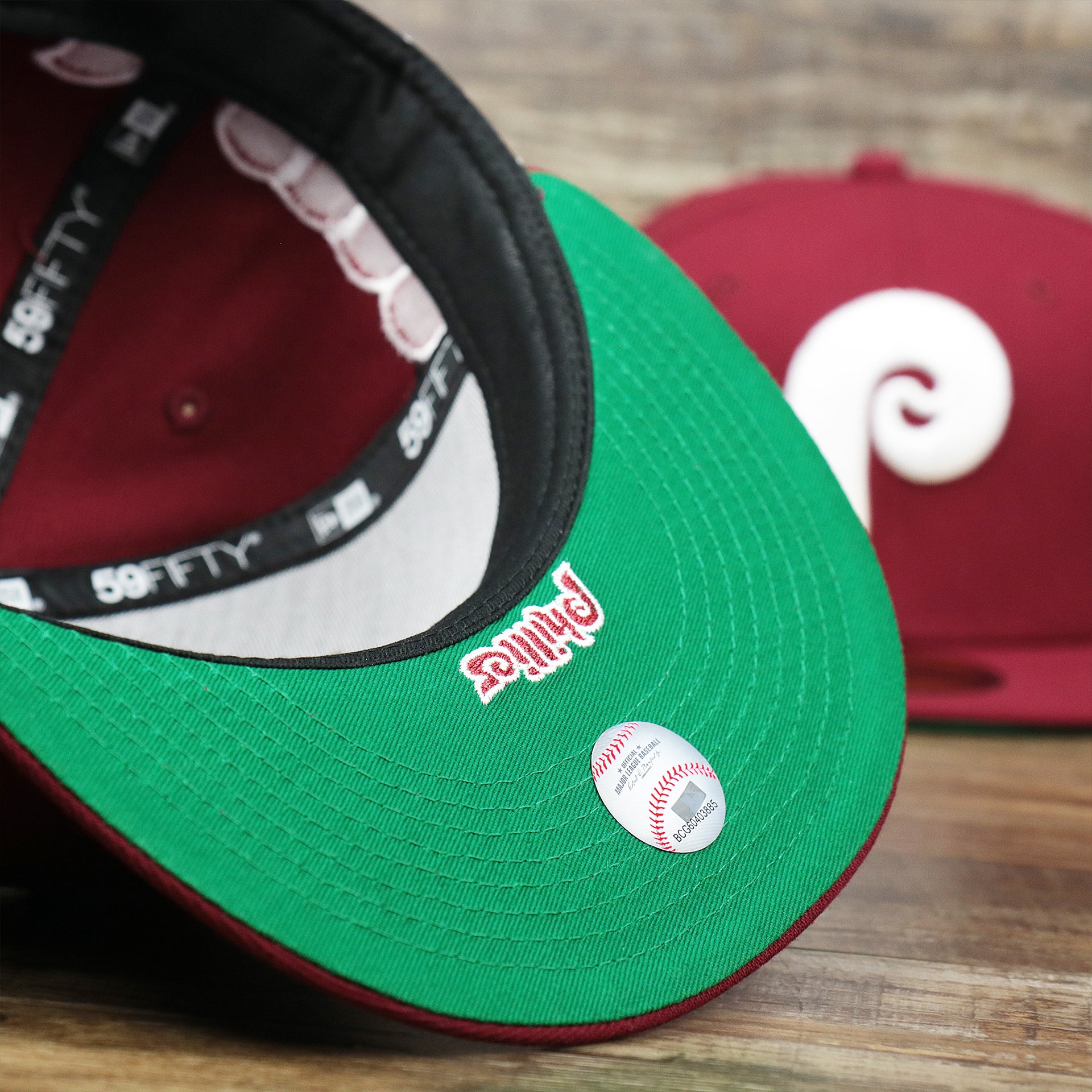 The Green Undervisor on the Cooperstown Philadelphia Phillies Wordmark Side Split Vintage Green Bottom With Phillies Embroidered Undervisor Fitted Cap | Maroon Blue 59Fifty Cap