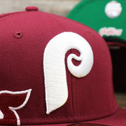 The Phillies Cooperstown Logo on the Cooperstown Philadelphia Phillies Wordmark Side Split Vintage Green Bottom With Phillies Embroidered Undervisor Fitted Cap | Maroon Blue 59Fifty Cap