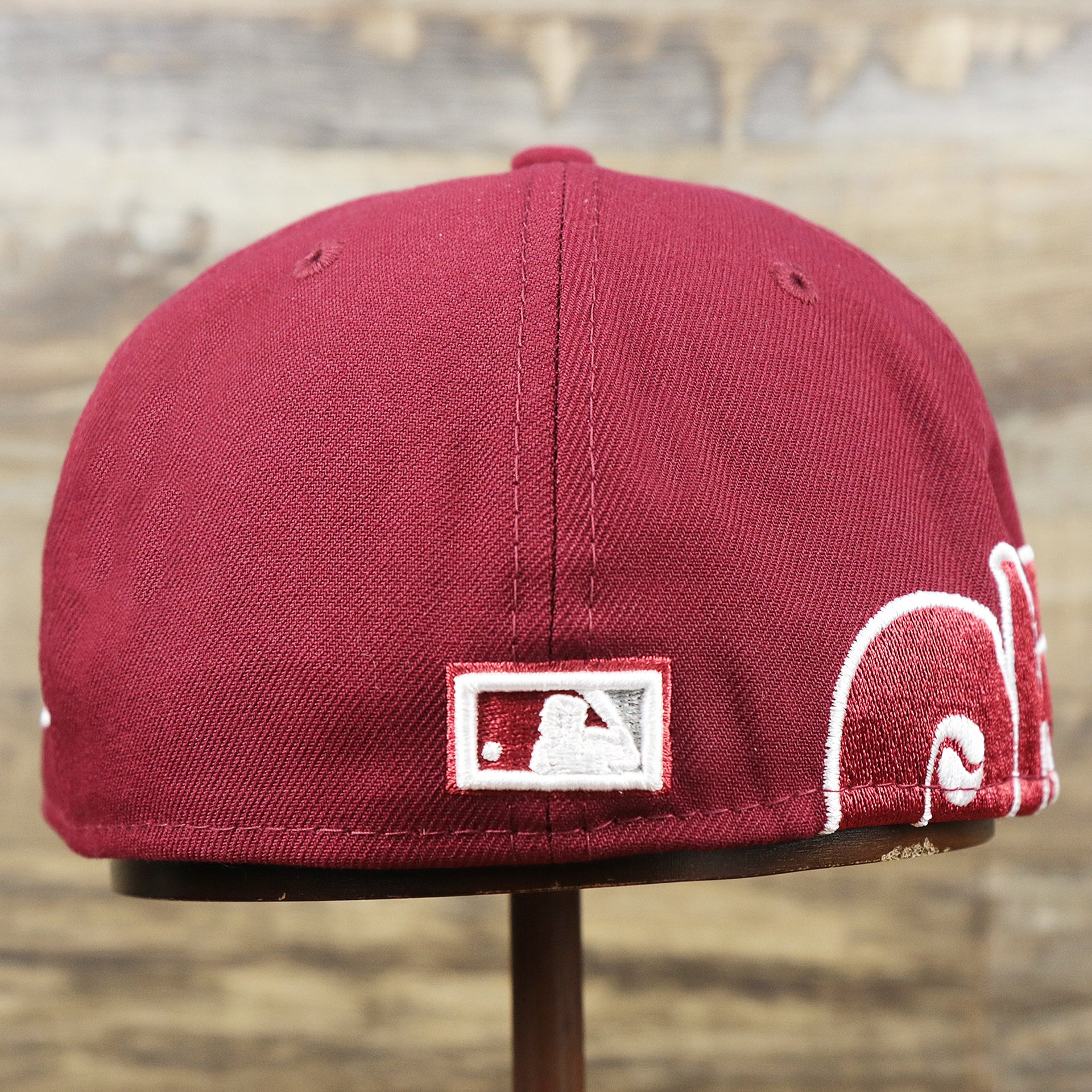The backside of the Cooperstown Philadelphia Phillies Wordmark Side Split Vintage Green Bottom With Phillies Embroidered Undervisor Fitted Cap | Maroon Blue 59Fifty Cap