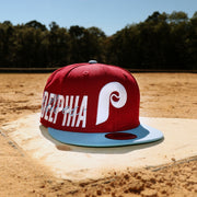The Cooperstown Philadelphia Phillies MLB Side Font Green Bottom 9Fifty Snapback Cap | Maroon Snap Cap on a baseplate