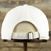 The backside of the Youth Light Blue OCNJ Wordmark Pink Outline Dad Hat | Youth White Dad Hat