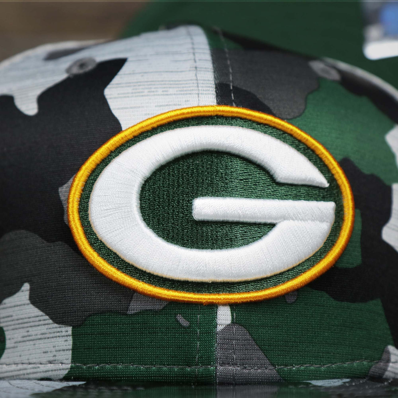 The Packers Logo on the Green Bay Packers NFL OnField Summer Training 2022 Camo 9Fifty Snapback | Green Camo 9Fifty