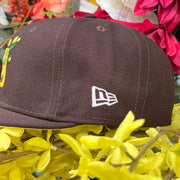 Wearer's left of the San Diego Padres Side Patch Bloom Walnut 59Fifty Fitted Cap | Padres Floral 5950 Fitted