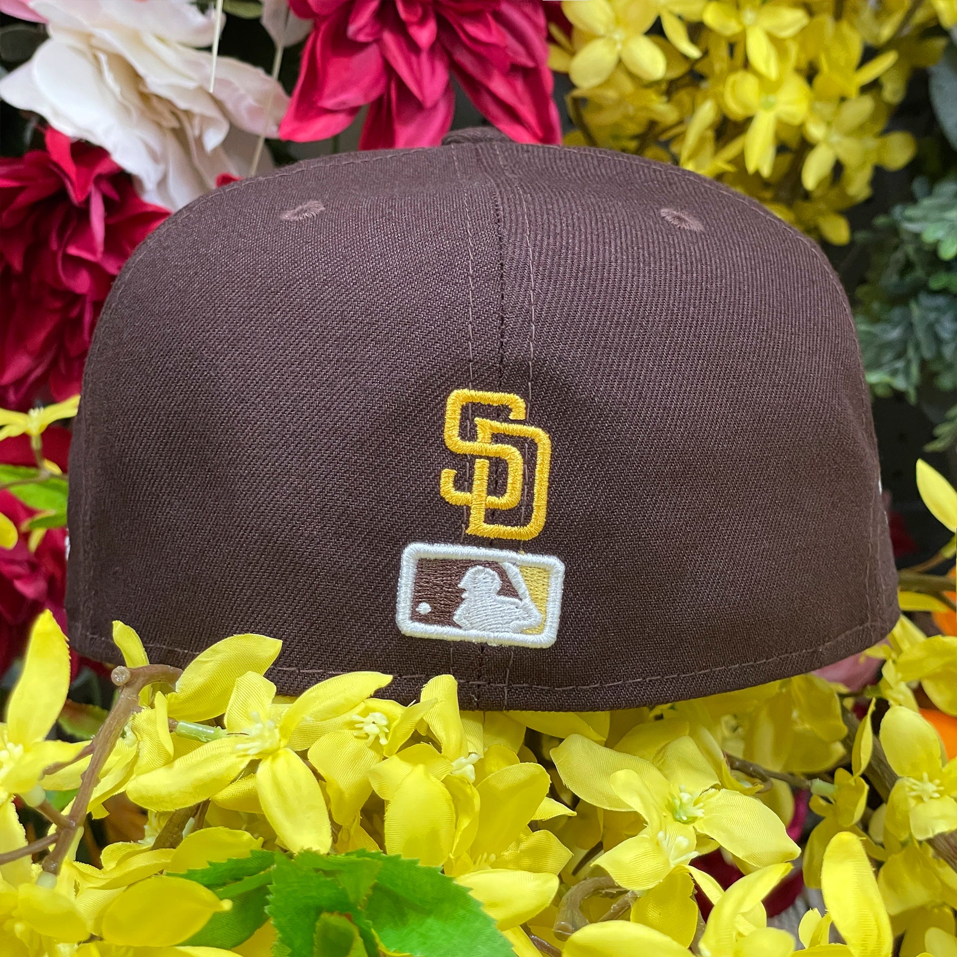 MLB Batterman logo along with the San Diego Padres logo on the back of the San Diego Padres Side Patch Bloom Walnut 59Fifty Fitted Cap | Padres Floral 5950 Fitted