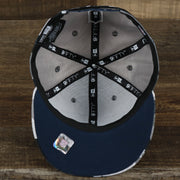 The underside of the New England Patriots NFL OnField Summer Training 2022 Camo 9Fifty Snapback | Navy Blue Camo 9Fifty
