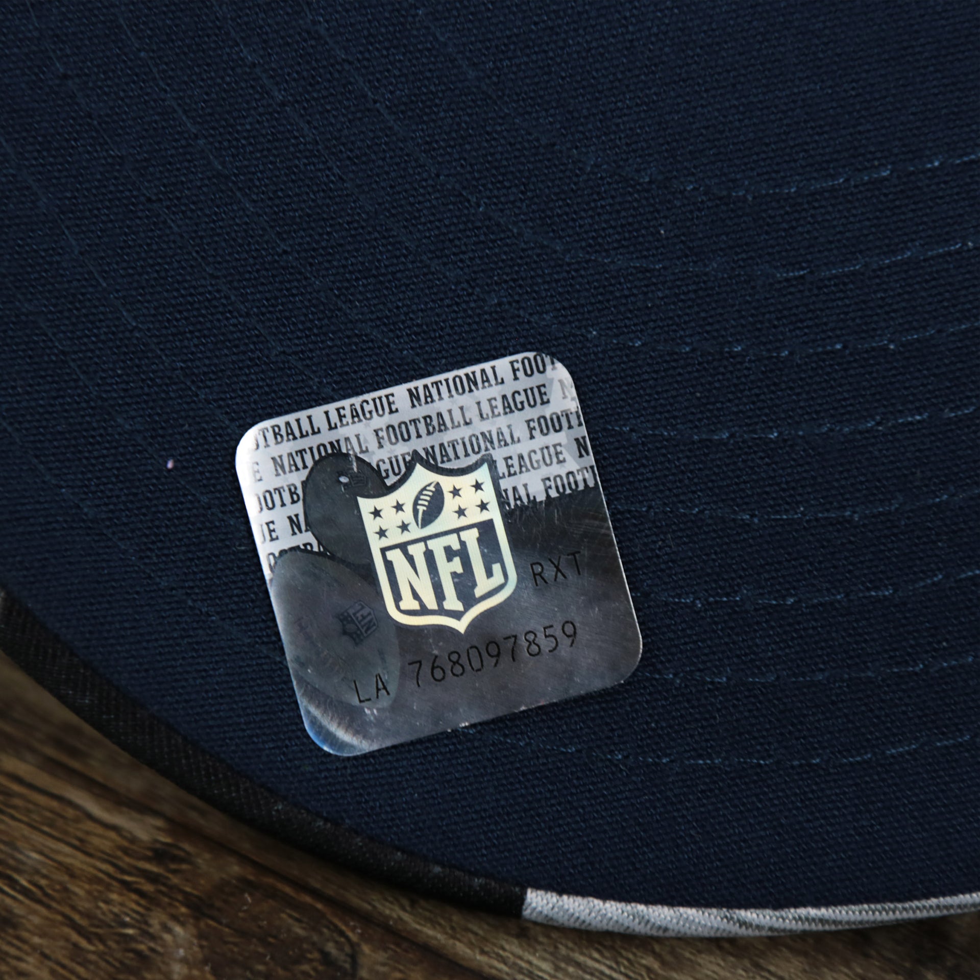 The NFL Sticker on theNew England Patriots NFL OnField Summer Training 2022 Camo 9Fifty Snapback | Navy Blue Camo 9Fifty