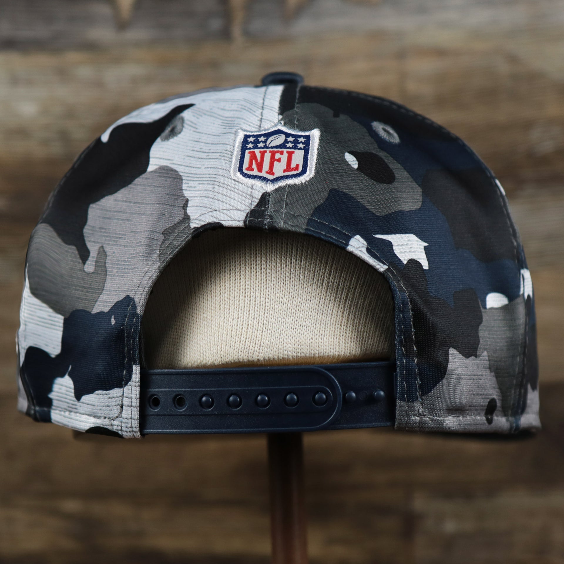 The backside of the New England Patriots NFL OnField Summer Training 2022 Camo 9Fifty Snapback | Navy Blue Camo 9Fifty